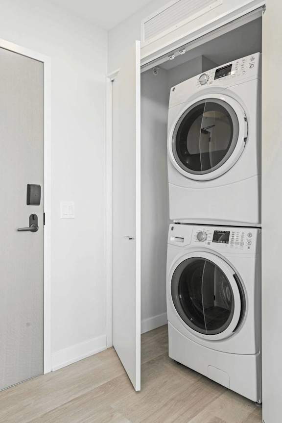 A white door is open to a white wall.