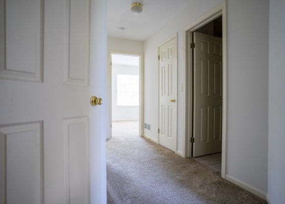 Upstairs hallway with entrances to bedrooms and bathroom