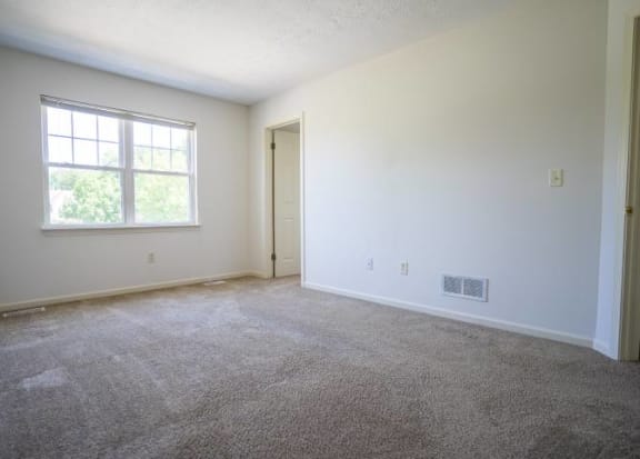 View of typical bedroom with carpet and closet