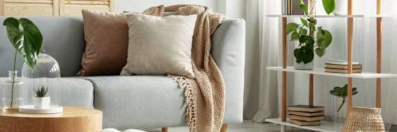 a living room with a couch and pillows on it