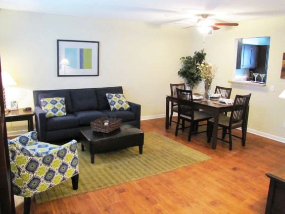 a living room with a couch and a dining room table at Midtown Park Townhomes, Raleigh, 27609