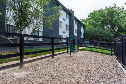 a fenced in area in front of an apartment building  at Capital Flats & Magnolia Square Apartments, Raleigh, North Carolina