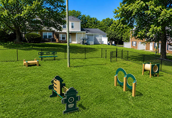 A playground with a green slide and a sign that says Green.