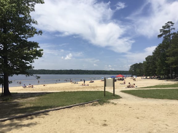A beach scene with people enjoying the sun and sand.