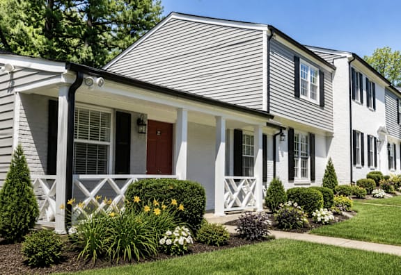 A house with a grey siding and white trim.
