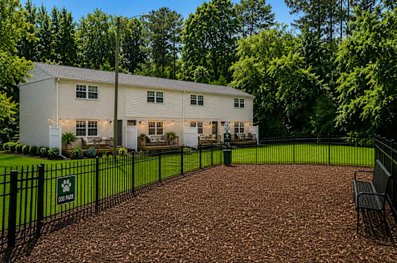 A white house with a black fence and a sign that says "Dix Hill".