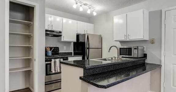 a kitchen with a sink and a refrigerator