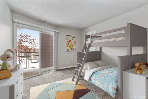 a bedroom with a bunk bed and a sliding glass door
