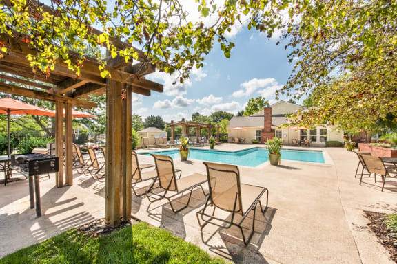 our apartments have a resort style pool with chairs and tables