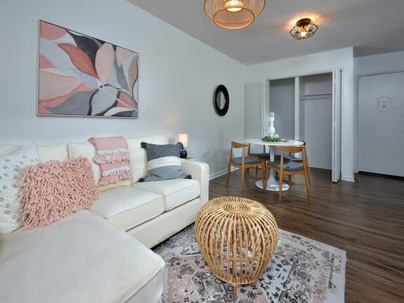 a living room and dining room with a couch and a table at Capital Flats &amp; Magnolia Square Apartments, Raleigh, NC, 27601
