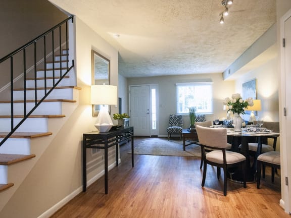 a living room and dining room with a staircase in a house at Parkside at Five Points, Raleigh