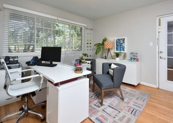a home office with a large window and a desk with a computer at Parkside at Five Points, Raleigh