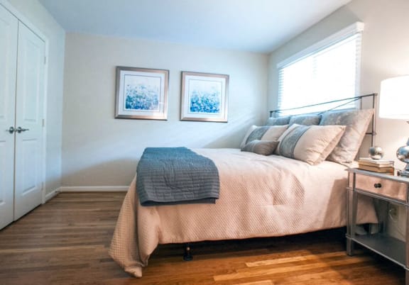 a bedroom with a bed and two pictures on the wall at Parkside at Five Points, Raleigh