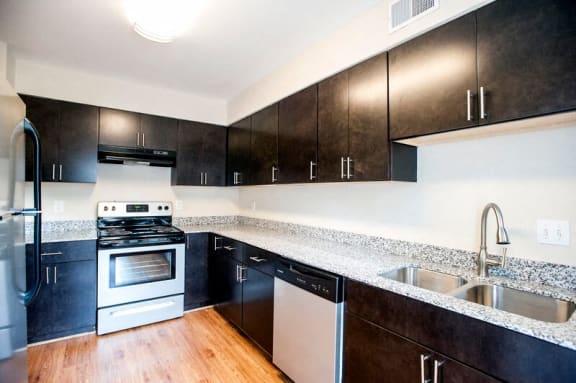 a kitchen with a stove and a sink at Parkside at Five Points, Raleigh