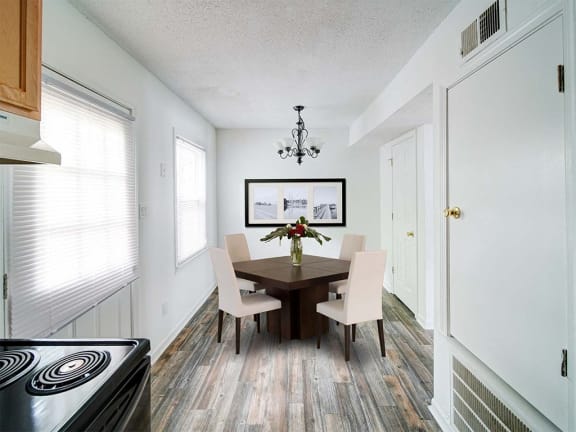 a dining room with a table and chairs
