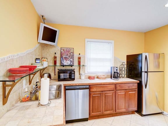 a kitchen with a refrigerator and a sink