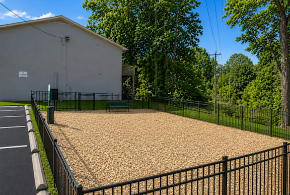 A small building with a parking lot in front of it.