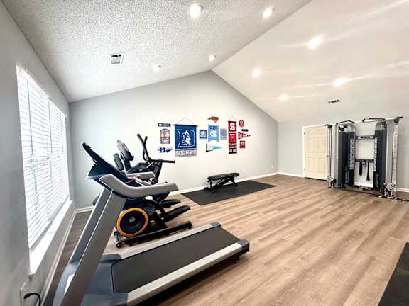 A gym with treadmills, weights, and exercise equipment.