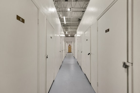 a row of white lockers in a prison hallway