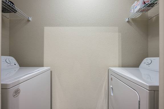 Two White Front Loading Washing Machines at Spring Creek Apartments, Crestview, FL