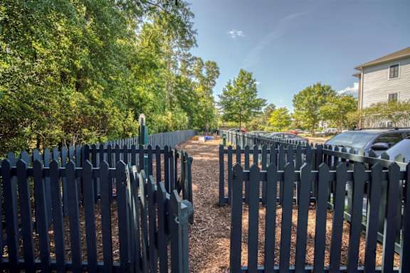 A long row of black picket fences line a tree-lined street at Cypress River, Ladson, South Carolina