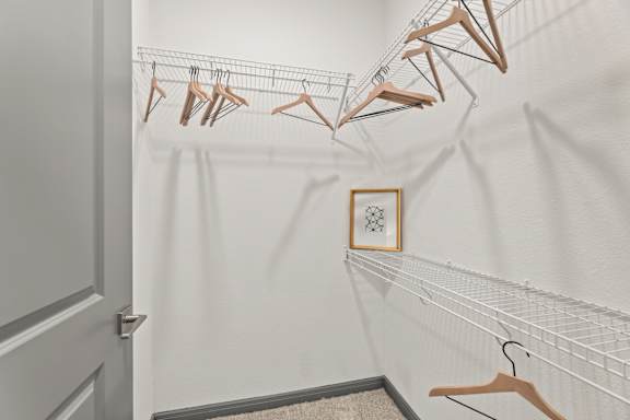 A row of clothes hangers on a rack in a room.