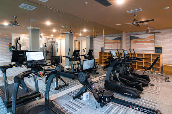 A gym with treadmills and exercise bikes at Hudson at Renaissance Apartments, North Carolina 28405