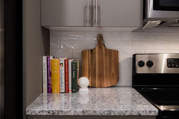 A row of cookbooks sits on a kitchen counter at Hudson at Renaissance Apartments, Wilmington, NC 28405