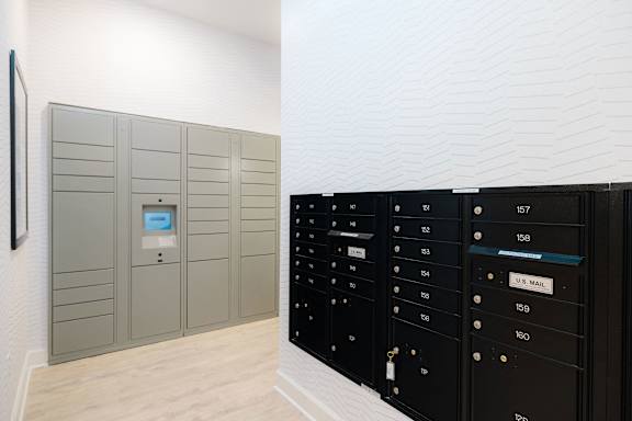 A row of mailboxes are lined up against a wall at Hudson at Renaissance Apartments, Wilmington, North Carolina
