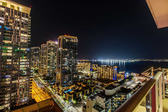 A cityscape at night with buildings and lights.