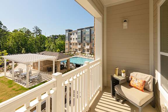 Private balcony with railing overlooking the pool