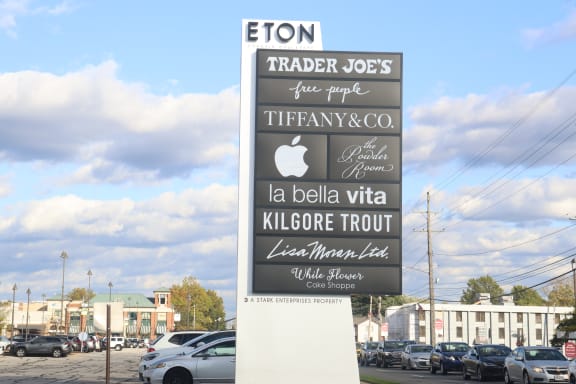 a sign for an apple trader joes store in a parking lot