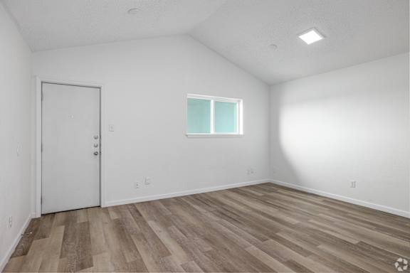 A room with a white door and a window with white frame.
