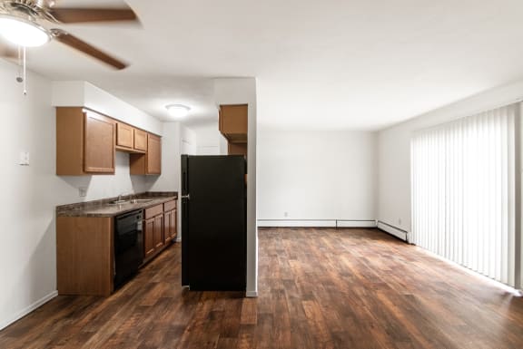 This is photo of the kitchen and living room from the dining room in the 560 square foot 1 bedroom apartment  at Aspen Village, Cincinnati