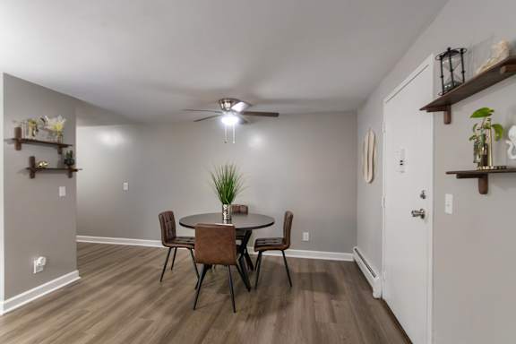 A dining room with a table and chairs in a 1 bedroom, 1 bath 560 square foot apartment at Aspen Village Apartments in the Westwood neighborhood of Cincinnati, OH.