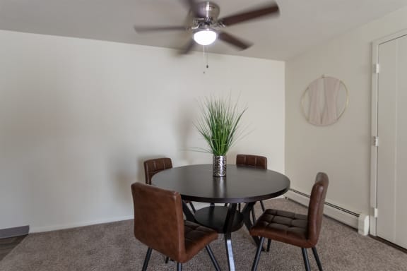 This is a photo of the dining area with ceiling fan in a 560 square foot, 1 bedroom, 1 bath apartment at Aspen Village Apartments in Cincinnati, OH.