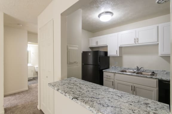 This is a photo of the living room closet and kitchen pass through in the 543 square foot A-style, 1 bedroom, 1 bath apartment at Blue Grass Manor Apartments in Erlanger, KY.