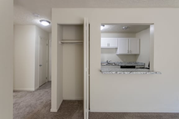 This is a photo of the living room closet and kitchen pass through in the 543 square foot A-style, 1 bedroom, 1 bath apartment at Blue Grass Manor Apartments in Erlanger, KY.