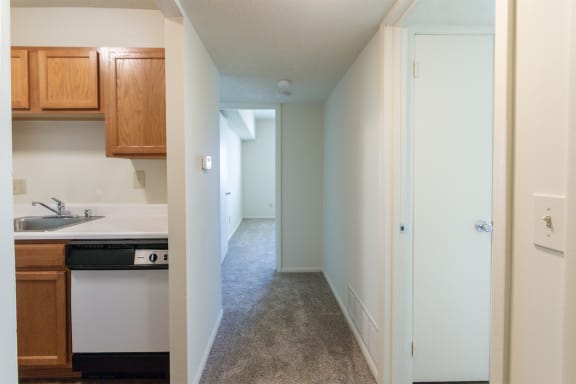 This is a photo of the kitchen and hallway from the entryway in the 652 square foot, 1 bedroom, 1 bath A-style apartment at Blue Grass Manor Apartments in Erlanger, KY.