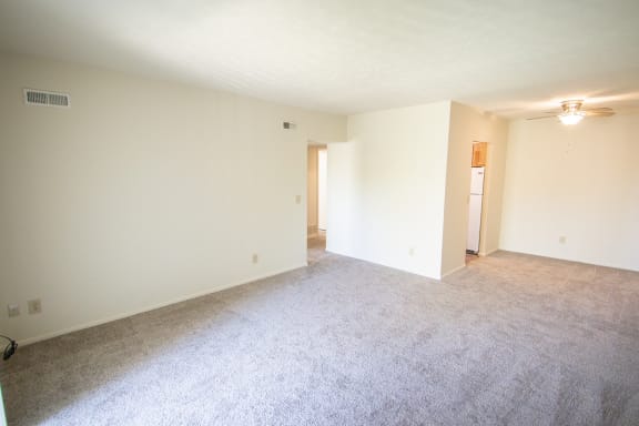 This is a photo of the living and dining rooms in the 652 square foot, 1 bedroom, 1 bath A-style apartment at Blue Grass Manor Apartments in Erlanger, KY.