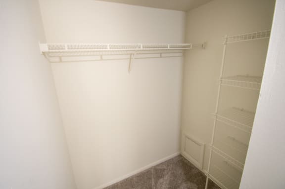This is a photo of the living room walk-in closet in the 899 square foot, 2 bedroom, 1 and a half bath apartment at Blue Grass Manor Apartments in Erlanger, KY.