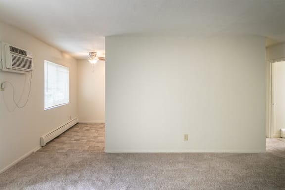 This is a photo of the living and dining rooms in the 865 square foot, 2 bedroom, 1 and a half bath apartment at Blue Grass Manor Apartments in Erlanger, KY.