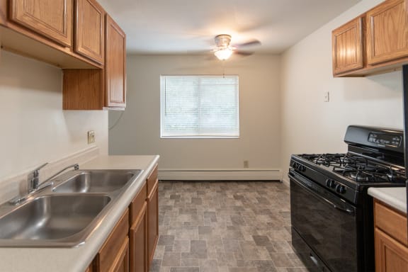 This is a photo of the kitchen and dining room in the 865 square foot, 2 bedroom, 1 and a half bath apartment at Blue Grass Manor Apartments in Erlanger, KY.