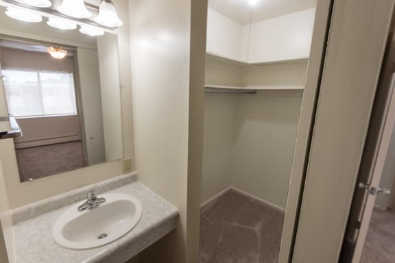 This is a photo of the walk-in closet in the master bedroom in the 865 square foot, 2 bedroom, 1 and a half bath apartment at Blue Grass Manor Apartments in Erlanger, KY.