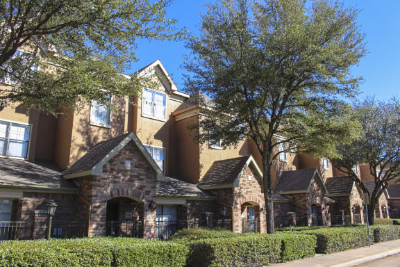 This is a photo of some Townhome exteriors at The Brownstones Townhome Apartments in Dallas, TX.