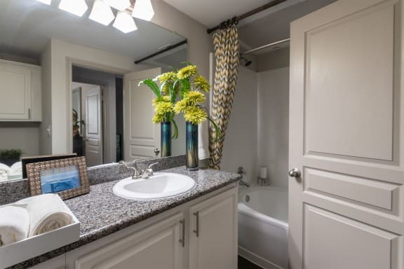 This is a photo of the bathroom of the 826 square foot 1 bedroom apartment at The Brownstones Townhome Apartments in Dallas, TX.