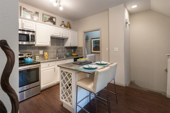 This is a photo of the kitchen in the 826 square foot 1 bedroom , 1 bath apartment at The Brownstones Townhome Apartments in Dallas, TX.