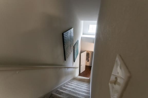 This is a photo of the stairwell from the 3rd floor in the 826 square foot 1 bedroom , 1 bath apartment at The Brownstones Townhome Apartments in Dallas, TX.