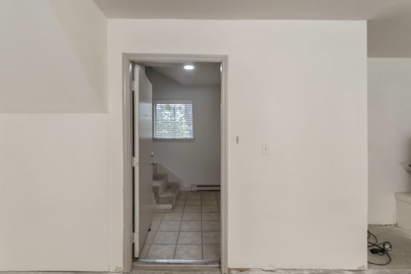 This is a picture of the entryway from the direct access garage of the 1320 square foot 2 bedroom, 2 and 1/2 bath floor plan at The Brownstones Townhome Apartments in Dallas, TX..