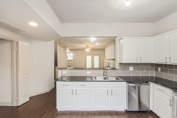 This is a picture of the kitchen of the 1320 square foot 2 bedroom, 2 and 1/2 bath floor plan at The Brownstones Townhome Apartments in Dallas, TX..